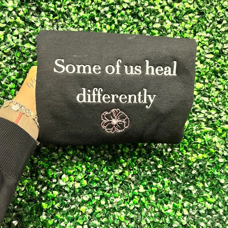 Some of us heal differently embroidered sweater